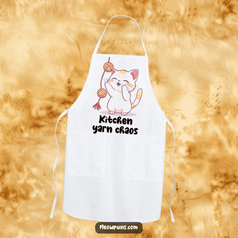 Funny cat playfully batting at a yarn ball on an apron, perfect for kitchen or craft room use.