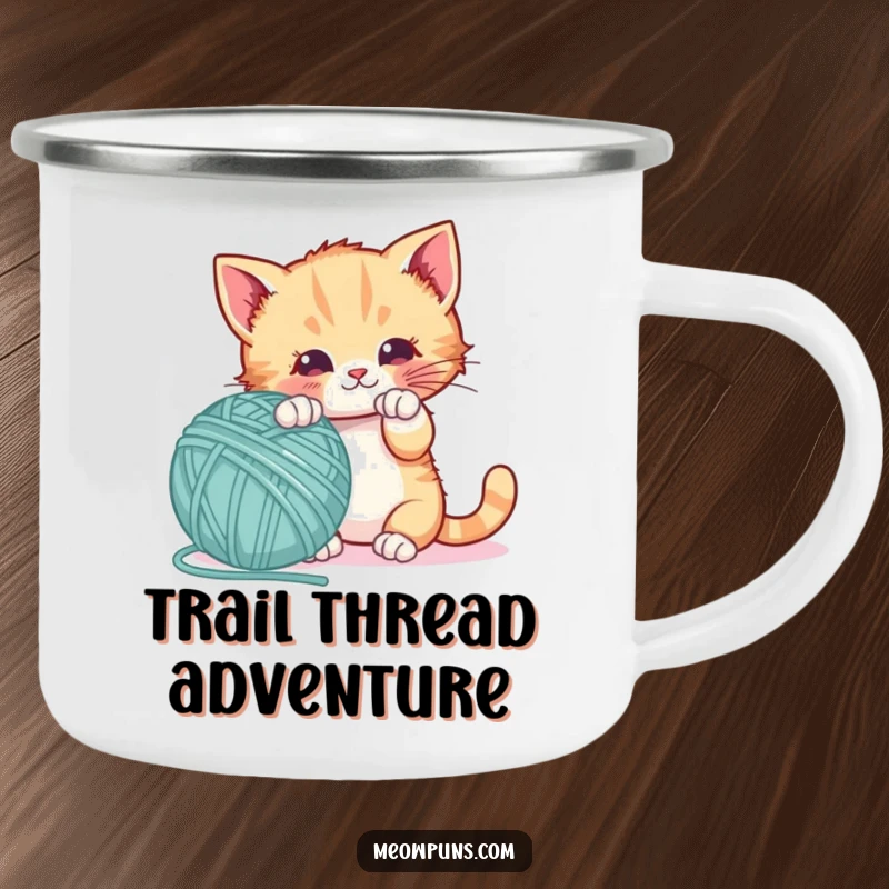 Funny camping mug with a playful kitten batting a giant letter-shaped yarn ball, perfect for outdoor learning and fun.
