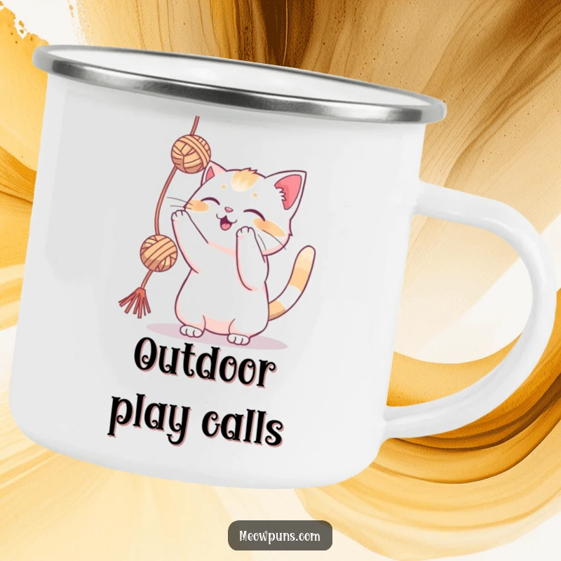 Funny cat playfully batting at a yarn ball on a camping mug, perfect for outdoor cat enthusiasts.