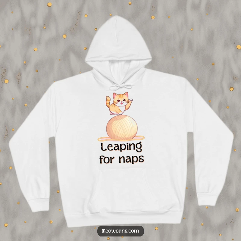 Funny hoodie depicting a cat spectacularly leaping over an oversized ball of yarn, full of playful action.