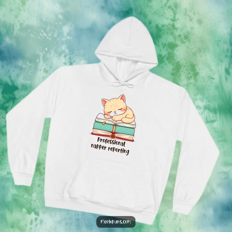 Funny hoodie featuring a peaceful cat napping atop an enormous book, embodying humor and comfort.